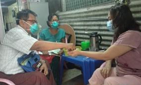 Daw Naw Ro Da taking anti-TB drugs from the PGK volunteer on a daily checkup visit. Photo: Pyi Gyi Khin